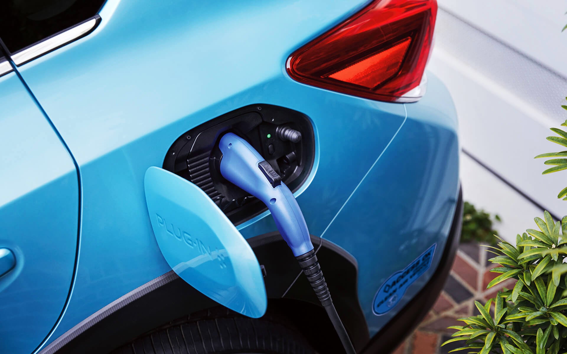 A close-up of the Subaru Crosstrek Hybrid's charging port with charging cable plugged in | Subaru of Ann Arbor in Ann Arbor MI