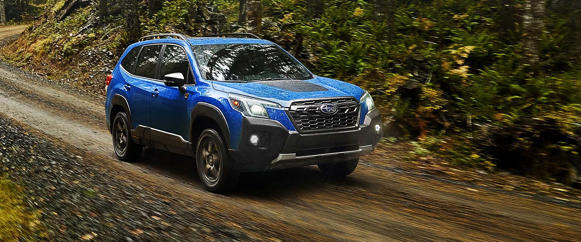 A 2022 Forester driving on a highway. | Subaru of Ann Arbor in Ann Arbor MI