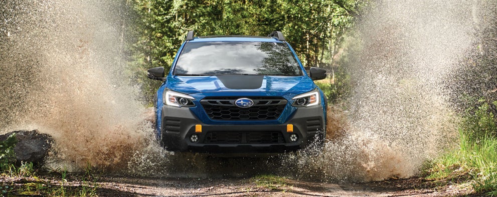 A 2023 Outback Wilderness driving on a muddy trail. | Subaru of Ann Arbor in Ann Arbor MI